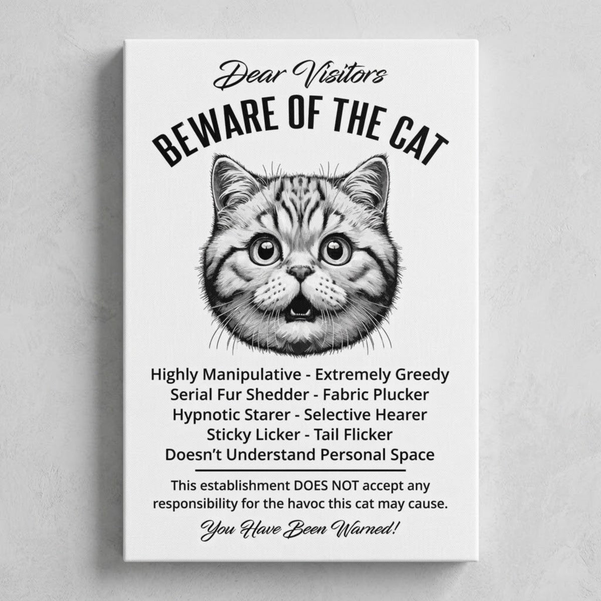 A rectangular white canvas sign with black printed funny text warning visitors about a British Shorthair cat, featuring a black-and-white illustration and humorous behavioral descriptions. The canvas print is photographed against a gray wall.
