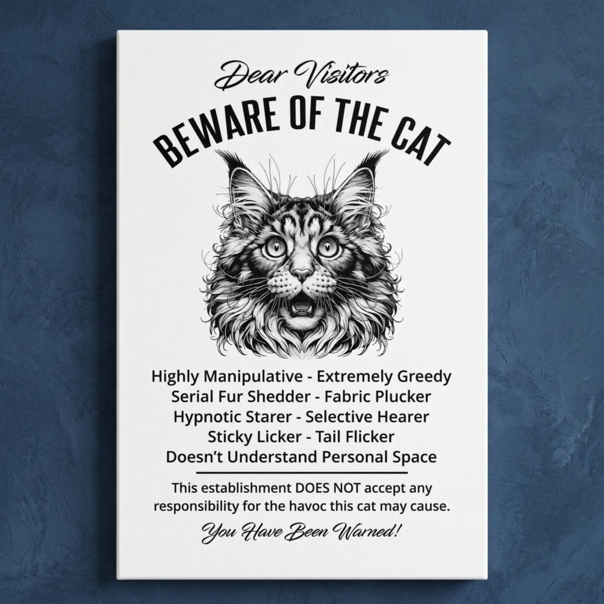 A rectangular white canvas sign with black printed funny text warning visitors about a Maine Coon cat, featuring a black-and-white illustration and humorous behavioral descriptions. The canvas print is photographed against a navy blue wall.