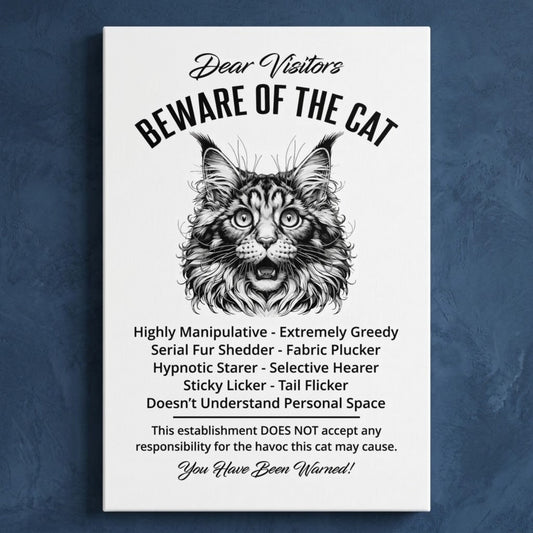A rectangular white canvas sign with black printed funny text warning visitors about a Maine Coon cat, featuring a black-and-white illustration and humorous behavioral descriptions. The canvas print is photographed against a navy blue wall.