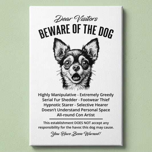 A rectangular white canvas sign with black printed funny text warning visitors about a Chihuahua dog, featuring a black-and-white face illustration and humorous behavioral descriptions. The canvas print is photographed against a light green wall.