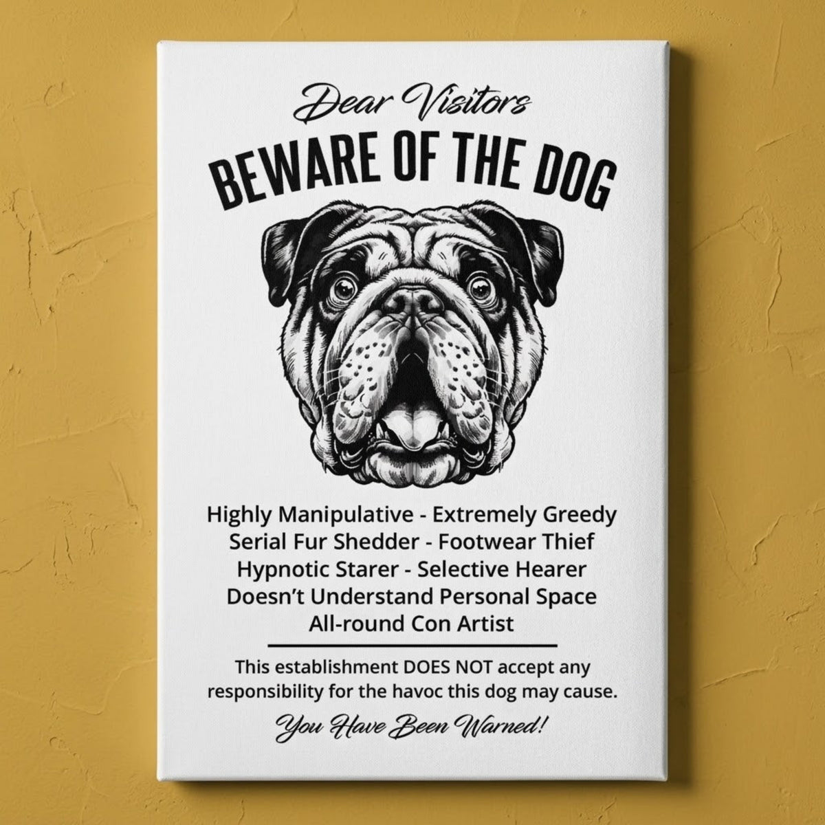 A rectangular white canvas sign with black printed funny text warning visitors about a English Bulldog, featuring a black-and-white face illustration and humorous behavioral descriptions. The canvas print is photographed against a orange plastered wall.
