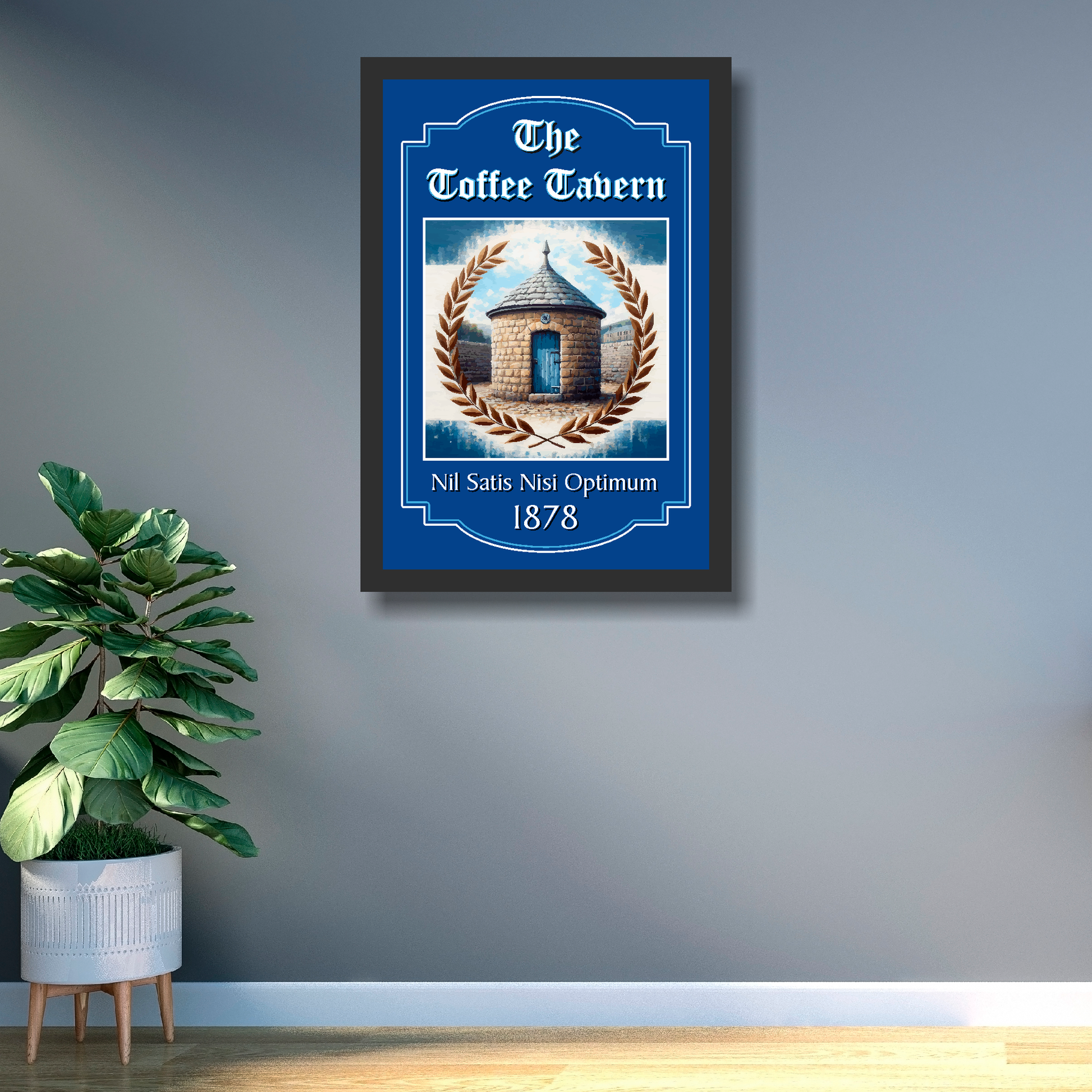 Everton FC framed artwork of 'The Toffee Tavern' with illustration on a gray wall with a plant below.