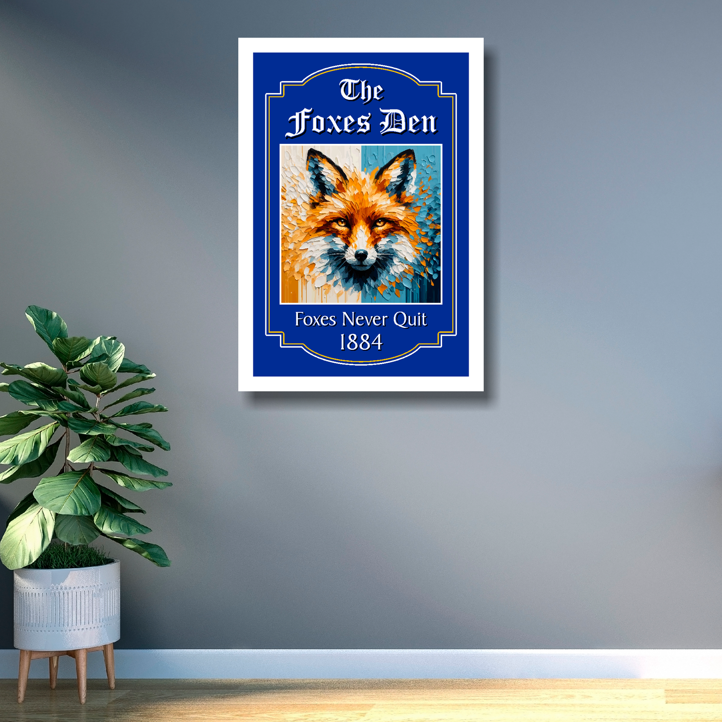 Leicester City white framed artwork of a fox with 'The Foxes Den' text on a wall next to a plant.