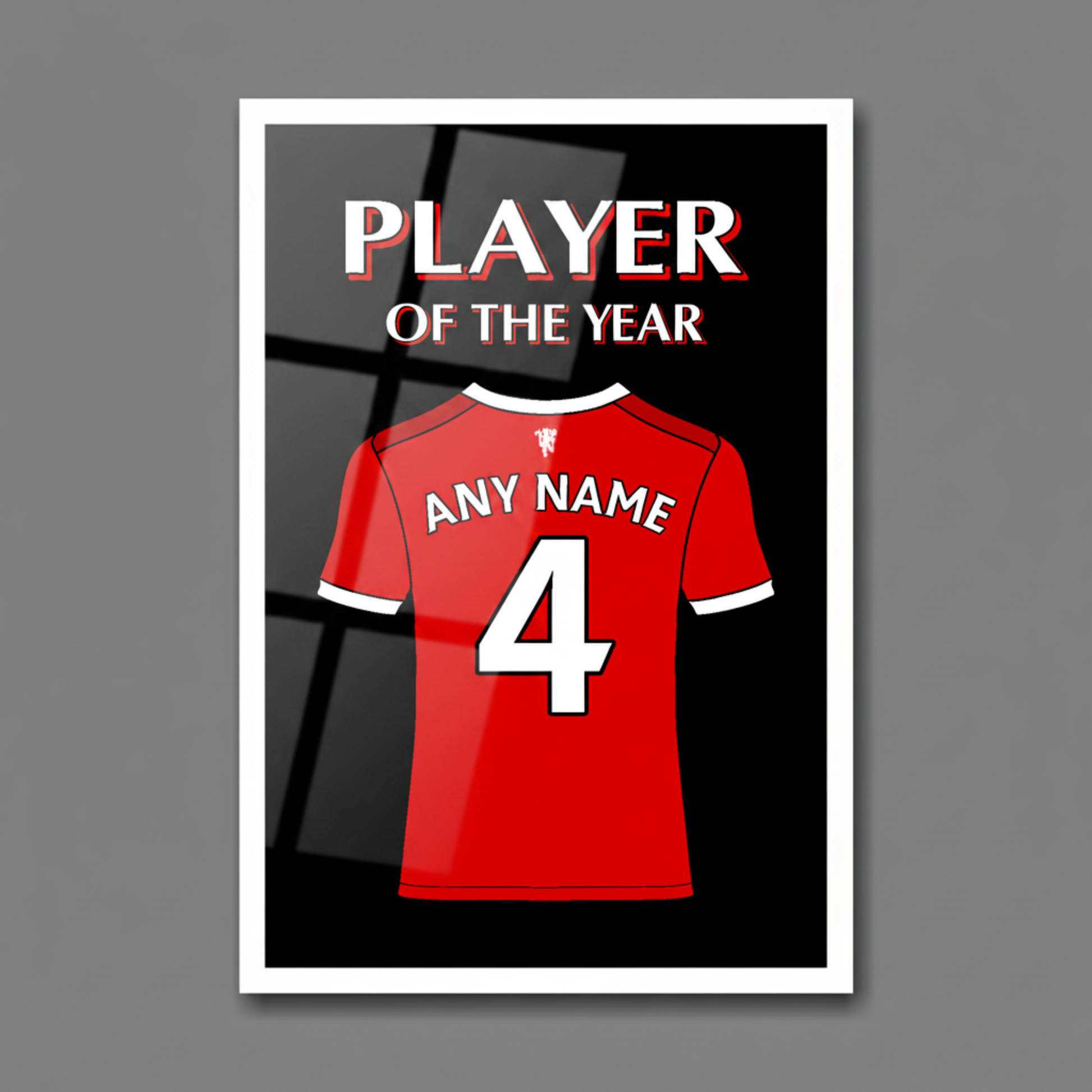 A personalised football shirt with the number 4 and 'ANY NAME' on the back,  with the text 'PLAYER OF THE YEAR' at the top. A large white framed art print on a gray background.