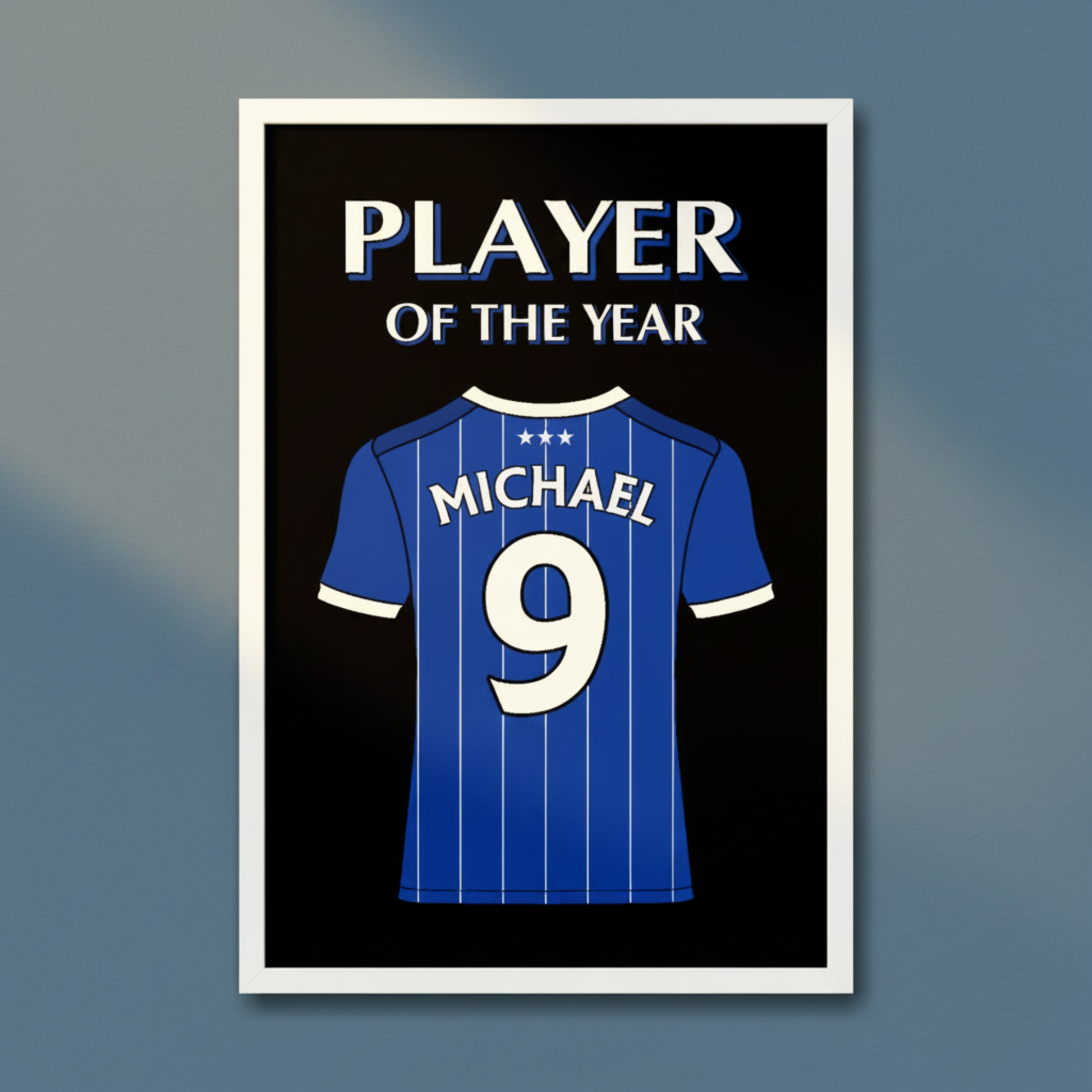 A framed art print featuring a blue ipswich football shirt with the name Michael and number 9 on the back, above the words 'PLAYER OF THE YEAR' on a black background.