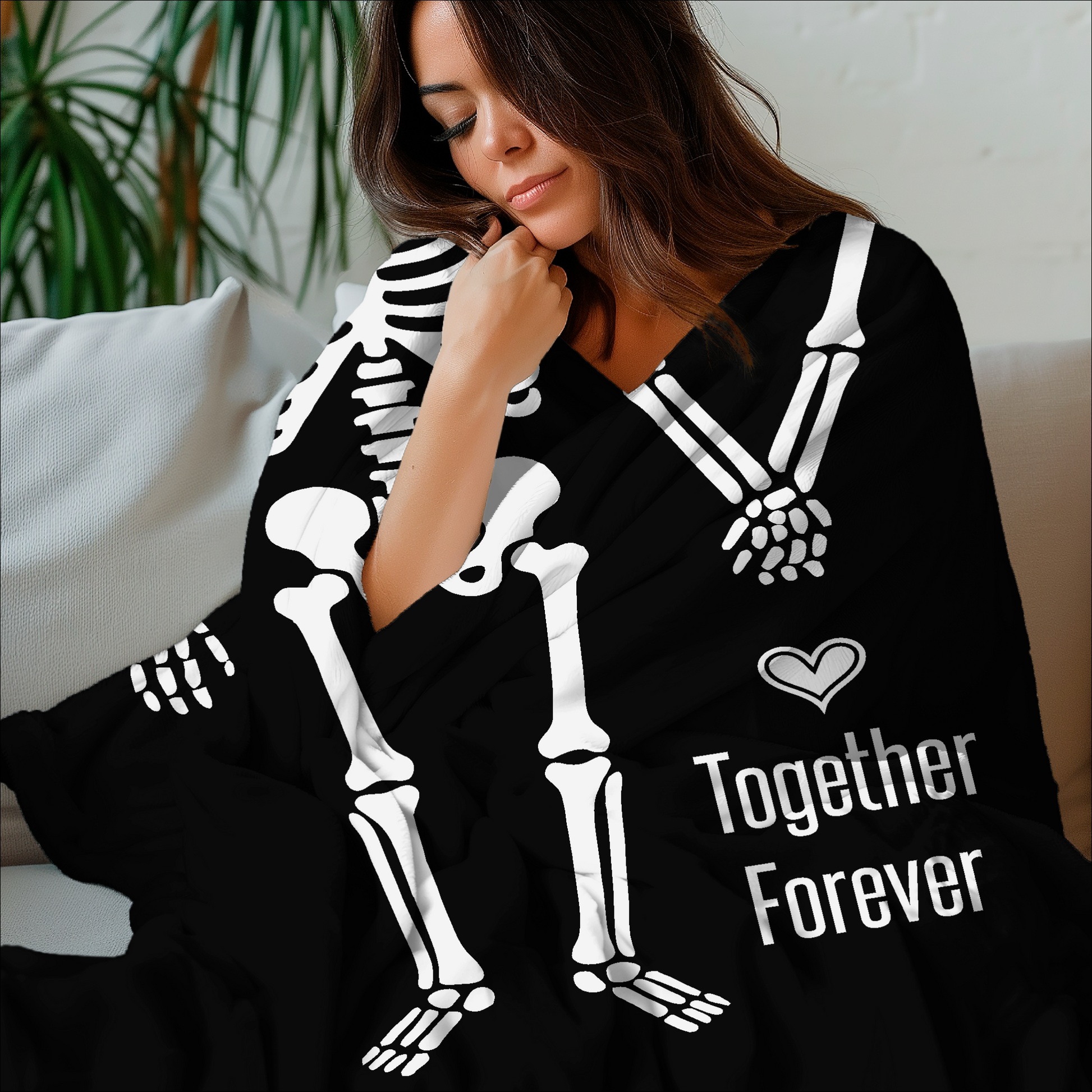 Woman wrapped in a black skeleton-themed blanket with 'Together Forever' text.